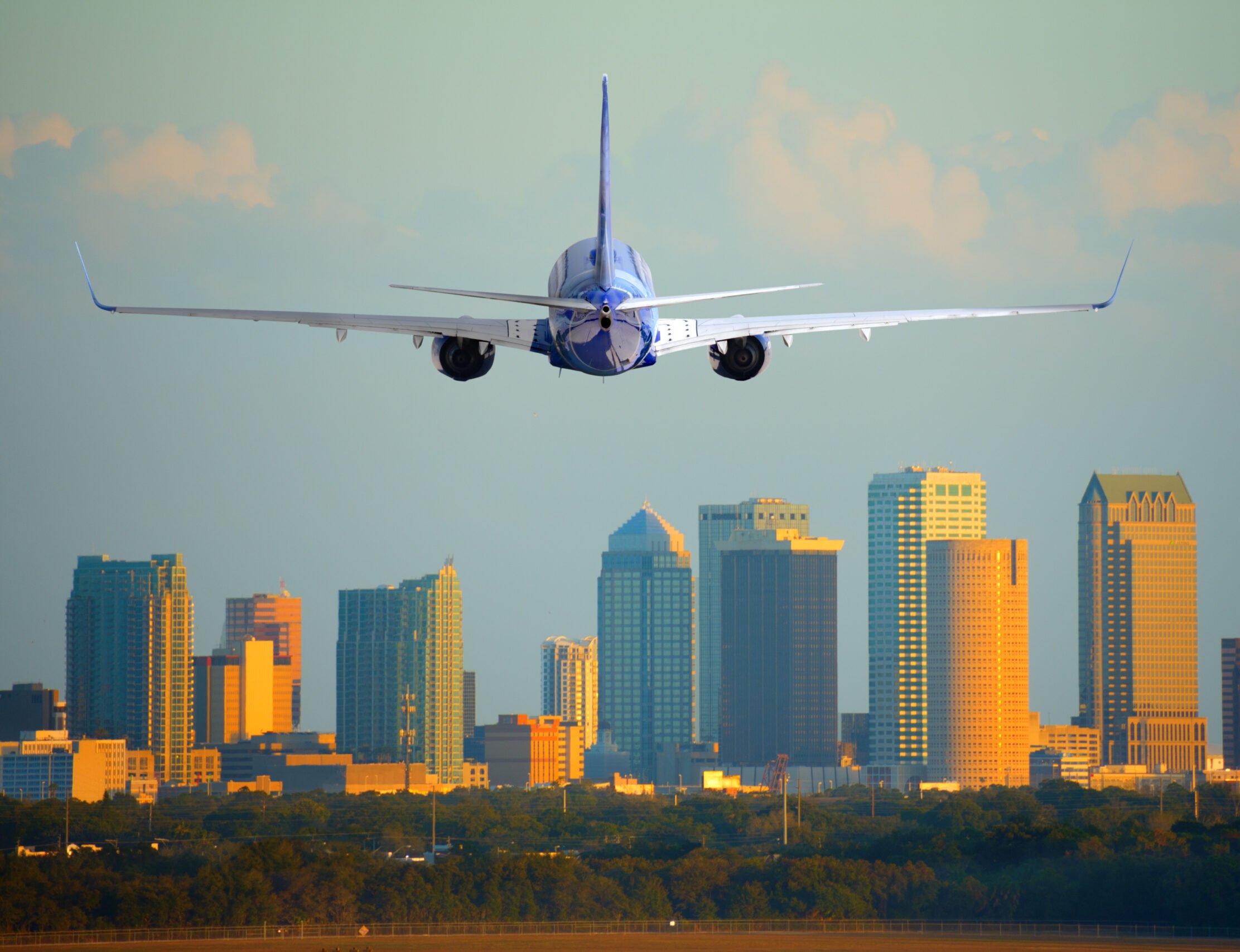 Passenger jet airliner plane arriving or departing Tampa International Airport in Florida at sunset or sunrise